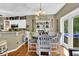 Charming dining area with a round table, stylish chairs, and french doors to the backyard at 4410 Red Rock Pt, Suwanee, GA 30024