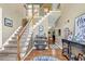 Inviting foyer with hardwood floors, staircase, and decorative accents at 4410 Red Rock Pt, Suwanee, GA 30024