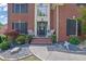 Close up of a welcoming entrance with decorative wreath, fresh flowers, and cozy seating at 4410 Red Rock Pt, Suwanee, GA 30024