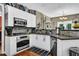 Modern kitchen equipped with stainless steel appliances and granite countertops at 4410 Red Rock Pt, Suwanee, GA 30024