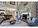 Inviting living room with a fireplace and large windows for natural light at 4410 Red Rock Pt, Suwanee, GA 30024