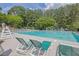 Community swimming pool with lounge chairs and lifeguard stand, ideal for summer relaxation at 4410 Red Rock Pt, Suwanee, GA 30024