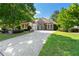 Charming home with a manicured lawn, stone accents, and a basketball hoop by the driveway, surrounded by mature trees at 931 Windsor Creek Dr, Grayson, GA 30017