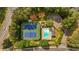 Aerial view of community pool and tennis courts with mature surrounding trees at 4181 Singing Post Ne Ln, Roswell, GA 30075