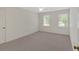 Spacious bedroom with neutral paint, carpet flooring, and two windows for natural light at 4181 Singing Post Ne Ln, Roswell, GA 30075