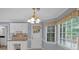 Bright breakfast nook with natural light, a built-in desk, and an adjacent door at 4181 Singing Post Ne Ln, Roswell, GA 30075