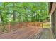 Exterior wooden deck with patterned railings and scenic, wooded views at 4181 Singing Post Ne Ln, Roswell, GA 30075