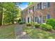Beautiful two-story brick home with blue shutters and meticulously landscaped yard, showcasing curb appeal at 4181 Singing Post Ne Ln, Roswell, GA 30075