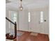 Bright foyer with hardwood floors, white wainscoting, and views of the staircase and front door at 4181 Singing Post Ne Ln, Roswell, GA 30075