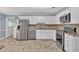 Spacious kitchen with stainless steel appliances, white cabinets, and tile flooring at 4181 Singing Post Ne Ln, Roswell, GA 30075
