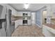 Modern kitchen with stainless steel appliances, ample cabinet space, and tile flooring at 4181 Singing Post Ne Ln, Roswell, GA 30075