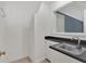 Bright laundry area features a stainless steel sink, black countertop, and a window providing natural light at 4181 Singing Post Ne Ln, Roswell, GA 30075