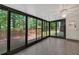 Bright sunroom with glass exterior walls providing access to a wooden deck at 4181 Singing Post Ne Ln, Roswell, GA 30075