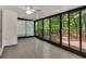 Bright sunroom with full glass exterior walls, ceiling fan, and tile flooring at 4181 Singing Post Ne Ln, Roswell, GA 30075