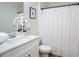 Bright bathroom with a white vanity and shower featuring a white curtain at 4966 Villager Ln, Stone Mountain, GA 30083