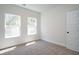 Well-lit bedroom with carpet, white walls, and windows offering natural light at 4966 Villager Ln, Stone Mountain, GA 30083