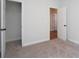 Spare bedroom features neutral decor, carpet, and walk-in closet at 4966 Villager Ln, Stone Mountain, GA 30083