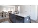 Kitchen island featuring a stainless steel dishwasher, grey cabinets, and granite countertops at 4966 Villager Ln, Stone Mountain, GA 30083