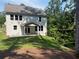The home's backyard features a covered patio area and level lot with privacy provided by mature trees at 93 Riverwood Dr, Dallas, GA 30157