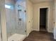 Bathroom showcasing glass shower with tiled walls and modern wood-look floors at 93 Riverwood Dr, Dallas, GA 30157