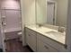 Bathroom with double sink vanity with quartz countertops and framed mirror at 93 Riverwood Dr, Dallas, GA 30157