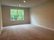 Bedroom featuring a bright window with wooded views and plush carpet at 93 Riverwood Dr, Dallas, GA 30157