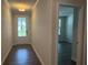 A view of the foyer showing the luxury vinyl plank flooring and the natural light from the entry door at 93 Riverwood Dr, Dallas, GA 30157