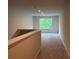 Upstairs hallway featuring neutral carpet, recessed lighting, and a window with a pleasant view at 93 Riverwood Dr, Dallas, GA 30157