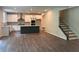 Open-concept kitchen and living space with an island, stainless appliances, and natural light at 93 Riverwood Dr, Dallas, GA 30157