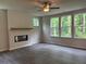 Inviting living room with a fireplace, wood mantle, and large windows with wooded views at 93 Riverwood Dr, Dallas, GA 30157
