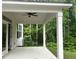 Covered patio with ceiling fan and wooded views at 93 Riverwood Dr, Dallas, GA 30157