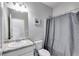 Bathroom featuring a shower with grey curtain, toilet, and vanity with granite countertop at 119 Sourwood Lane, Temple, GA 30179