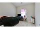 View of carpeted bedroom with small television atop a black media console at 119 Sourwood Lane, Temple, GA 30179