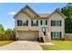 Charming two-story home with a well-manicured lawn, attached garage, and inviting front entrance at 119 Sourwood Lane, Temple, GA 30179