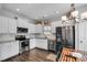 Modern kitchen featuring stainless steel appliances, granite countertops, and a cozy dining area at 119 Sourwood Lane, Temple, GA 30179