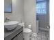 Bathroom featuring modern sink and patterned tile floor with a window view at 1390 Almont Sw Dr, Atlanta, GA 30310