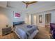 Bedroom with wood floors, ceiling fan, and a purple accent chair at 1390 Almont Sw Dr, Atlanta, GA 30310
