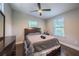 Bedroom with hardwood floors and natural lighting from windows and a ceiling fan at 1390 Almont Sw Dr, Atlanta, GA 30310