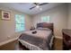 Cozy bedroom featuring hardwood floors, two windows, and a ceiling fan at 1390 Almont Sw Dr, Atlanta, GA 30310