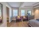 Bedroom with wood floors, ceiling fan, closet and purple accent chairs at 1390 Almont Sw Dr, Atlanta, GA 30310