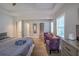 Bedroom featuring wood floors, ceiling fan, and purple accent chairs at 1390 Almont Sw Dr, Atlanta, GA 30310