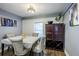 Cozy dining room featuring hardwood floors, neutral decor, and a large cabinet enhancing the inviting atmosphere at 1390 Almont Sw Dr, Atlanta, GA 30310