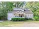 Charming home with dormer windows, a covered front porch and manicured landscaping at 1390 Almont Sw Dr, Atlanta, GA 30310
