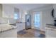 Bright kitchen featuring white cabinets, stainless steel appliances, granite countertops, and a convenient door to the backyard at 1390 Almont Sw Dr, Atlanta, GA 30310