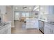 Modern kitchen featuring white cabinets, granite countertops, stainless steel appliances, and hardwood floors, creating a functional and stylish space at 1390 Almont Sw Dr, Atlanta, GA 30310