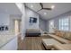 Bright living room featuring hardwood floors, a high ceiling with ceiling fan, and ample natural light, creating a cozy atmosphere at 1390 Almont Sw Dr, Atlanta, GA 30310