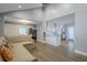 Open-concept living space featuring hardwood floors, grey walls, and a seamless transition to the adjacent dining and kitchen areas at 1390 Almont Sw Dr, Atlanta, GA 30310