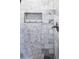 Elegant marble shower showcasing stylish hexagonal tile accents and a convenient built-in niche at 1390 Almont Sw Dr, Atlanta, GA 30310