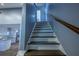 Inviting staircase leading to upper level, complemented by neutral walls and wood floors at 1390 Almont Sw Dr, Atlanta, GA 30310