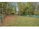 Backyard with mature trees and a wooden fence at 350 Rams Way, Tucker, GA 30084